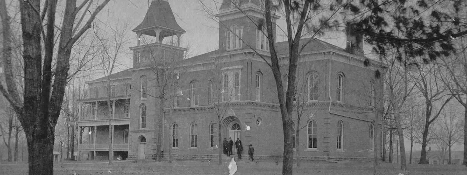 black 和 white photo of original campus building